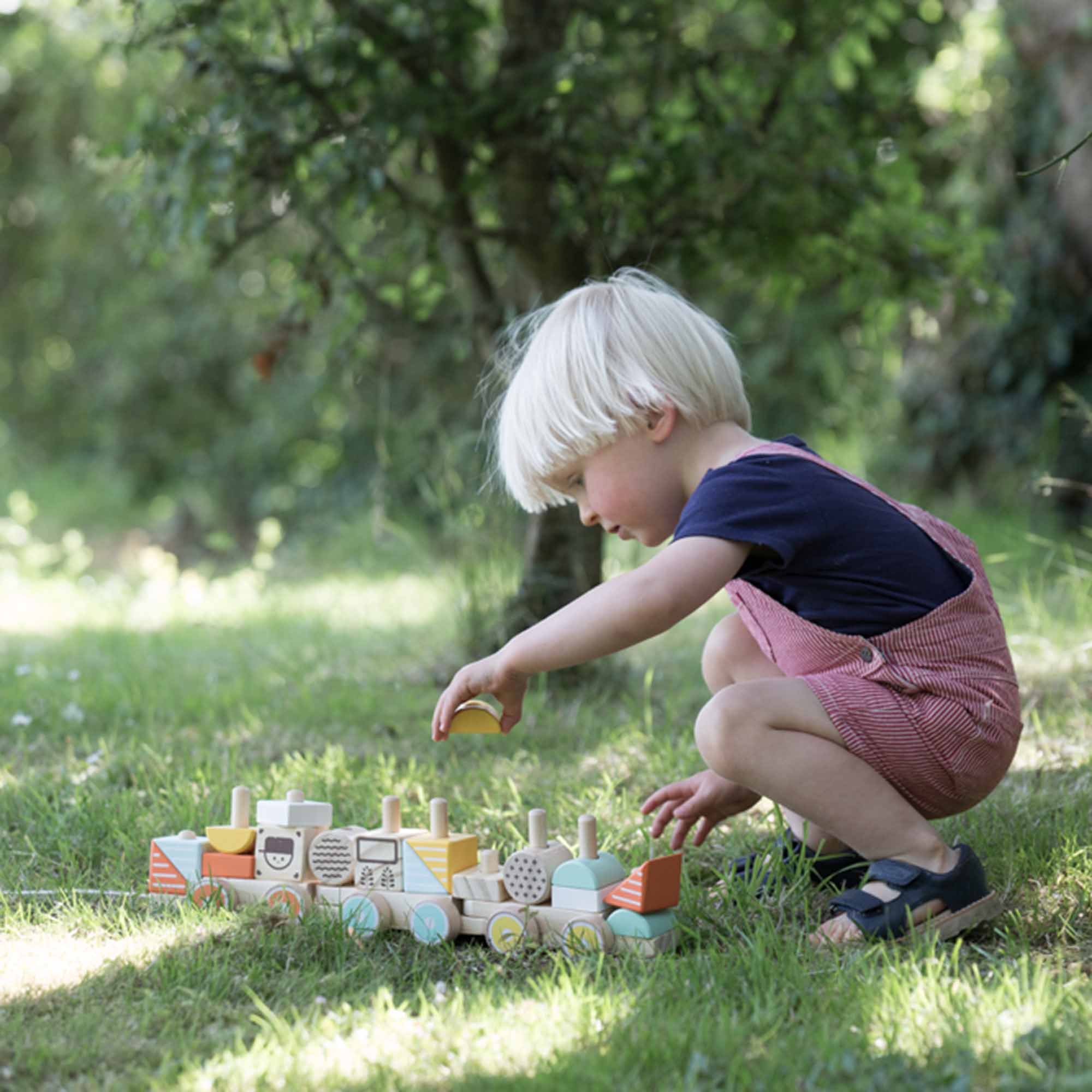 Boy playing with Classic World Pull Train