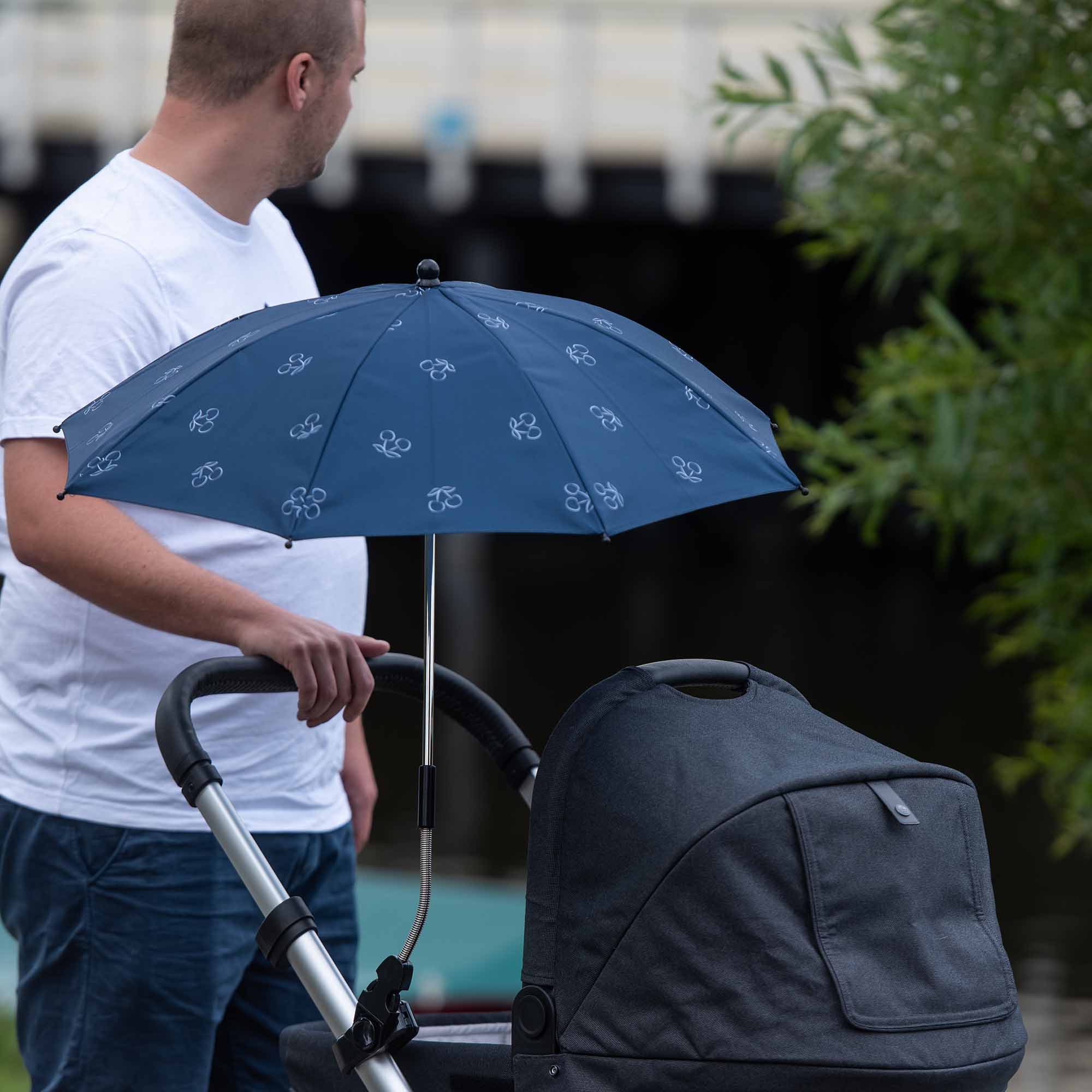 Dad pushing buggy with Blue Cherry Parasol