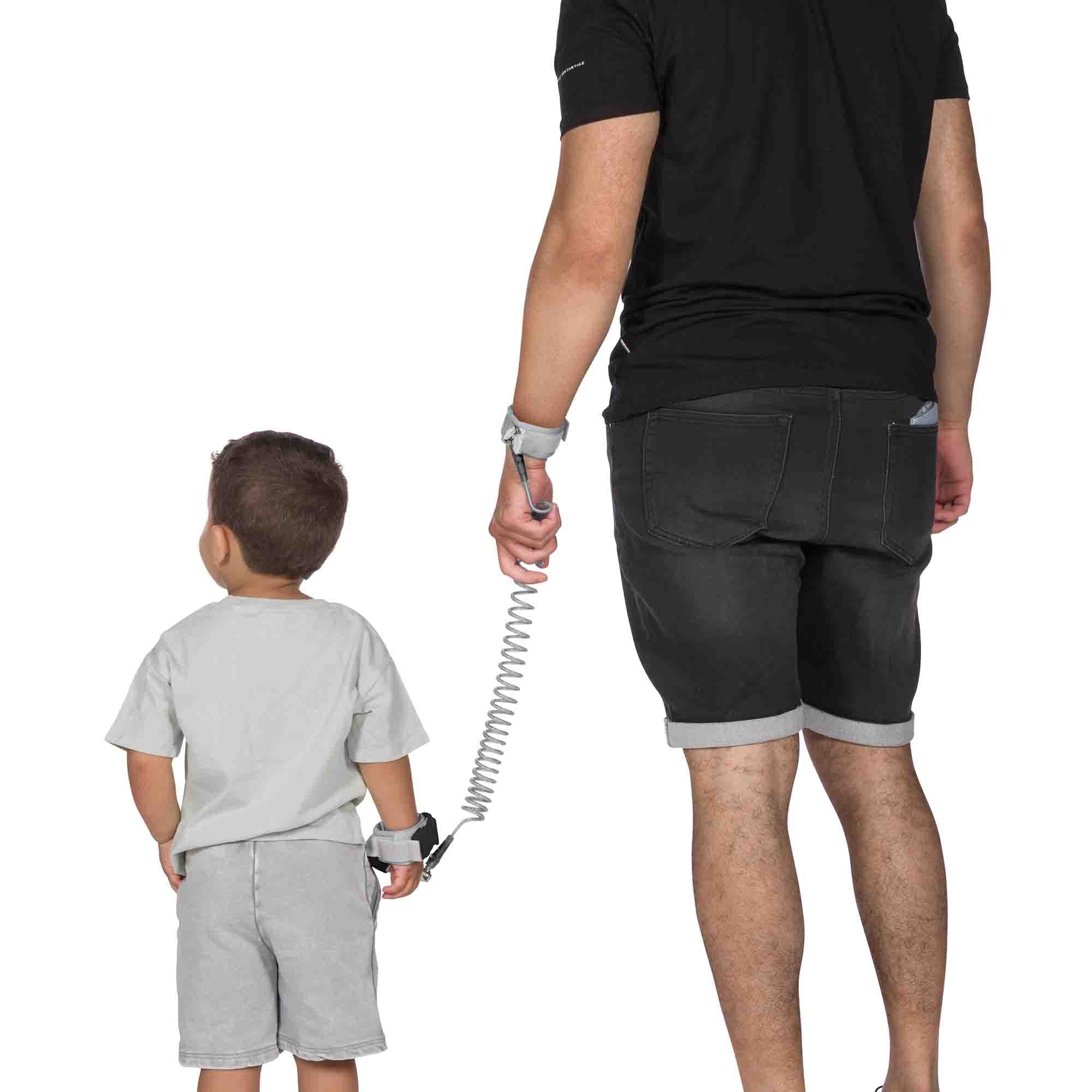 Child and parent holding hand with the Dooky Safety Wristband