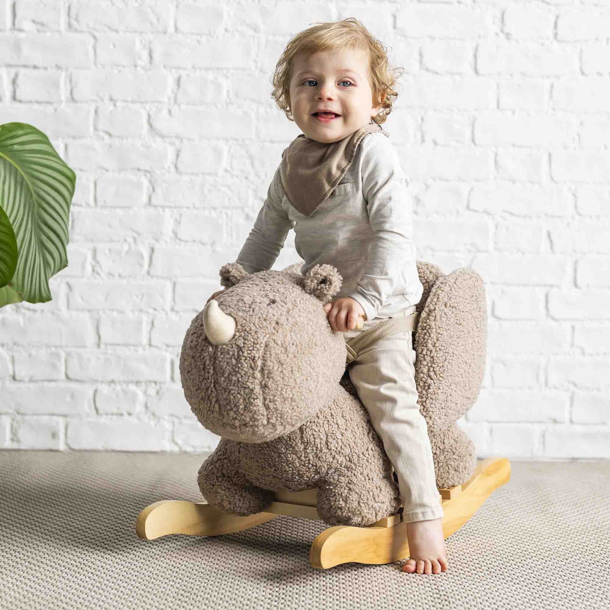 Child sitting on the Rhino Teddy Rocker