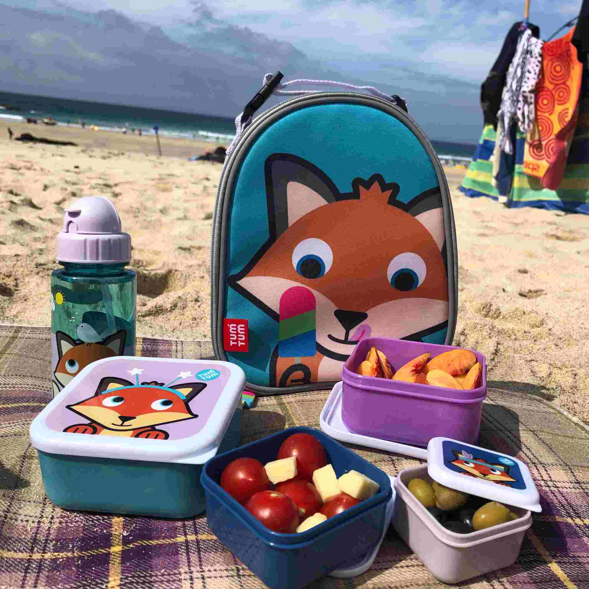 Felicity Fox lunch bag, bottle and snack pots on a picnic blanket at the beach