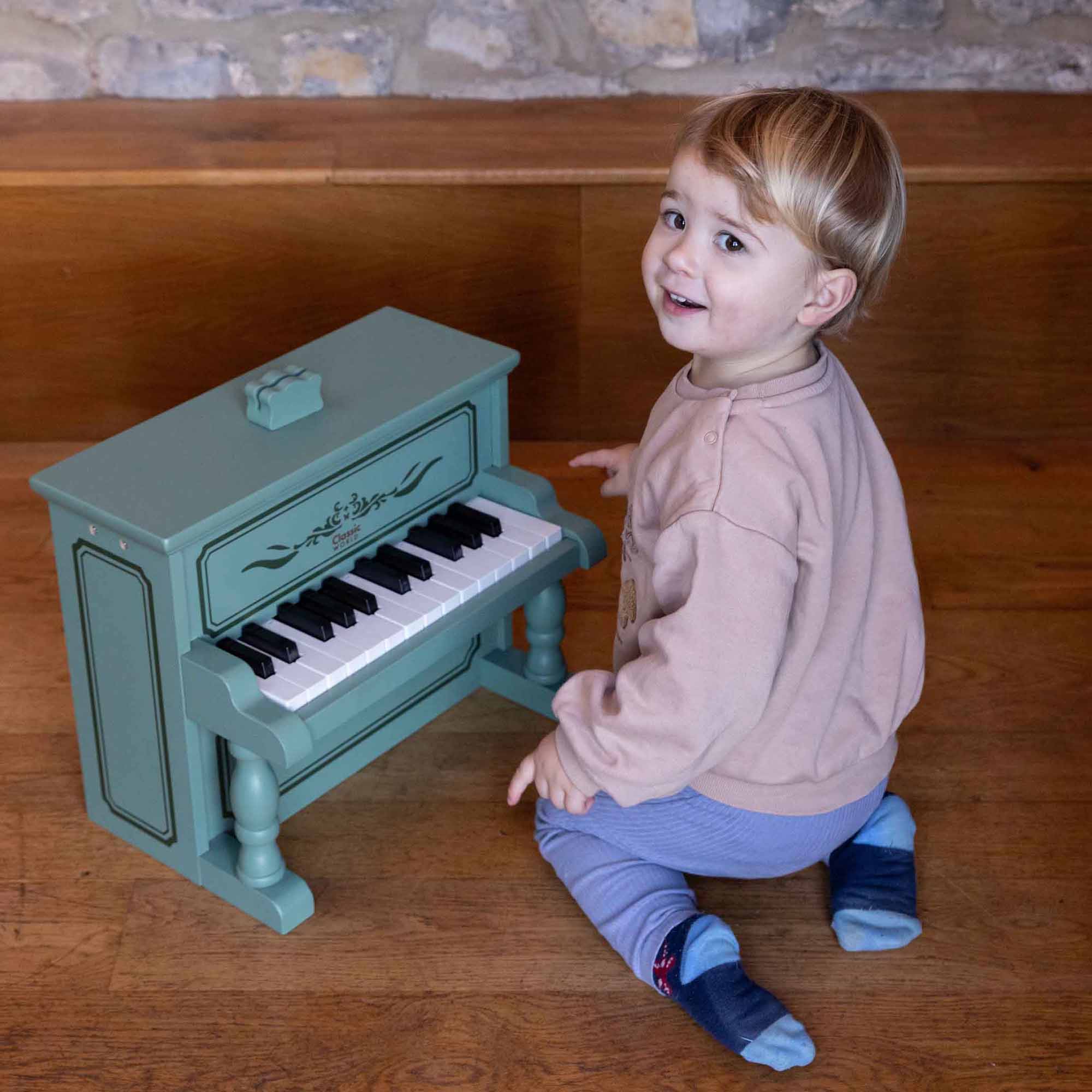 Little boy playing the Vintage piano