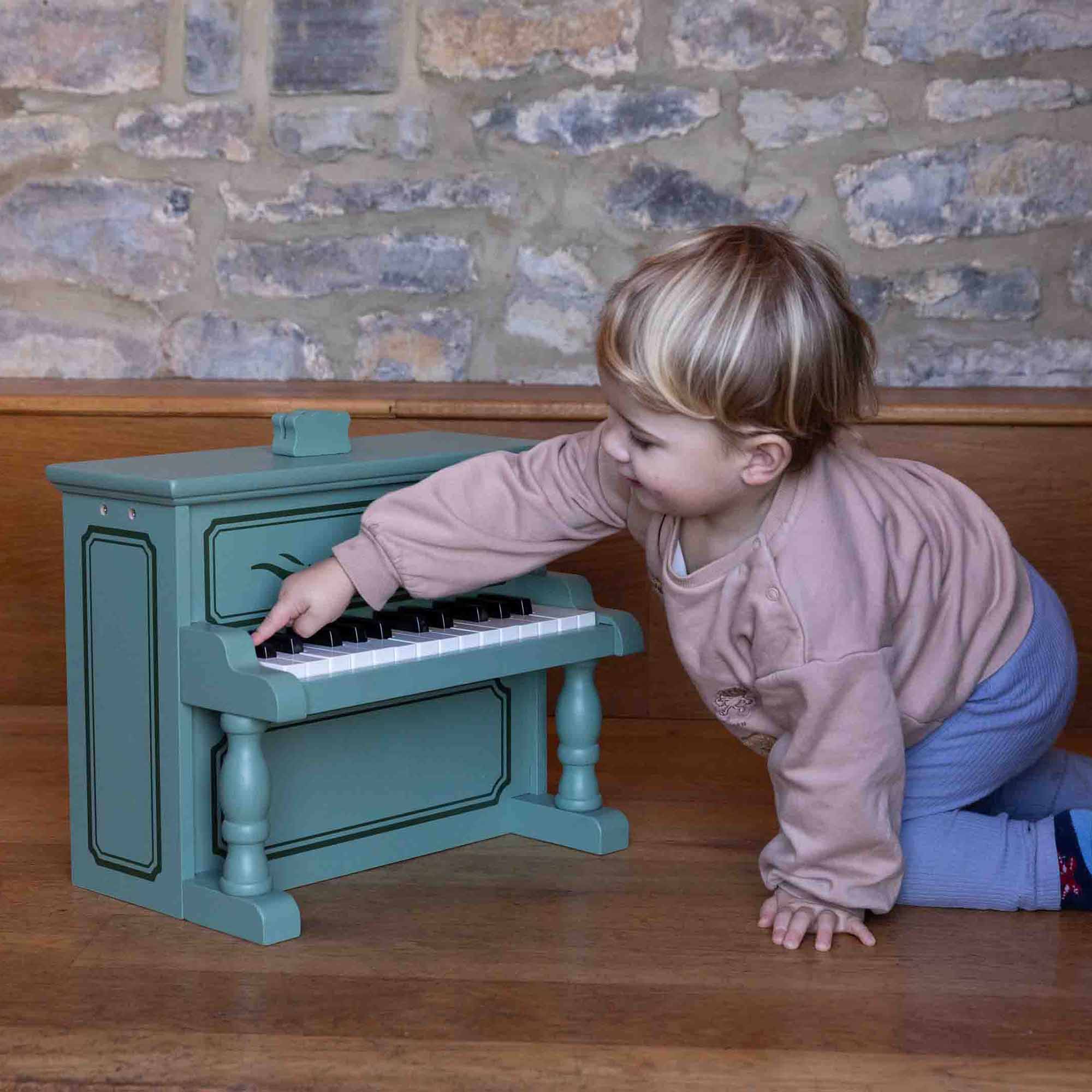 Little boy playing the Vintage piano