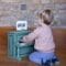 Little boy playing the Vintage piano