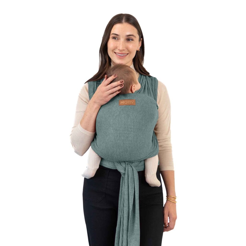 Mother wearing her baby in the Moby Waffle Knit Baby Wrap - Saguaro
