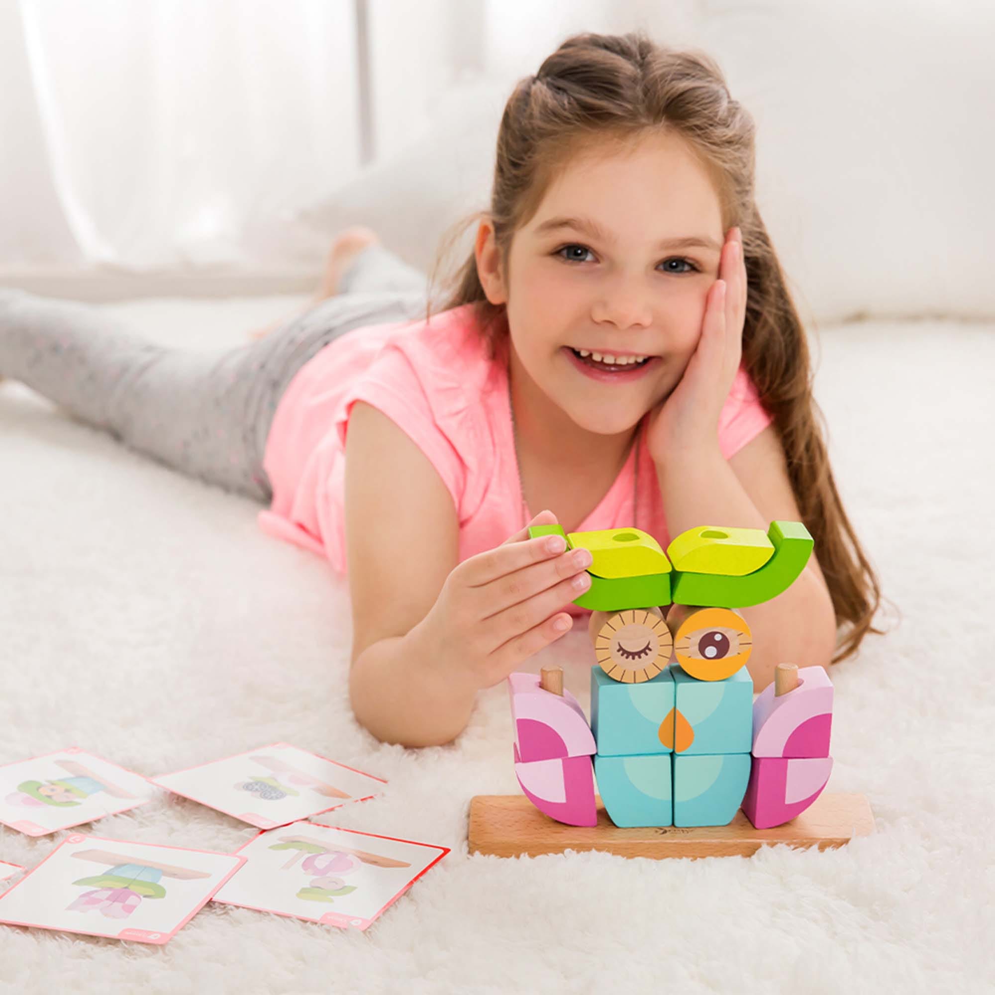 GIrl playing with Owl Blocks Set