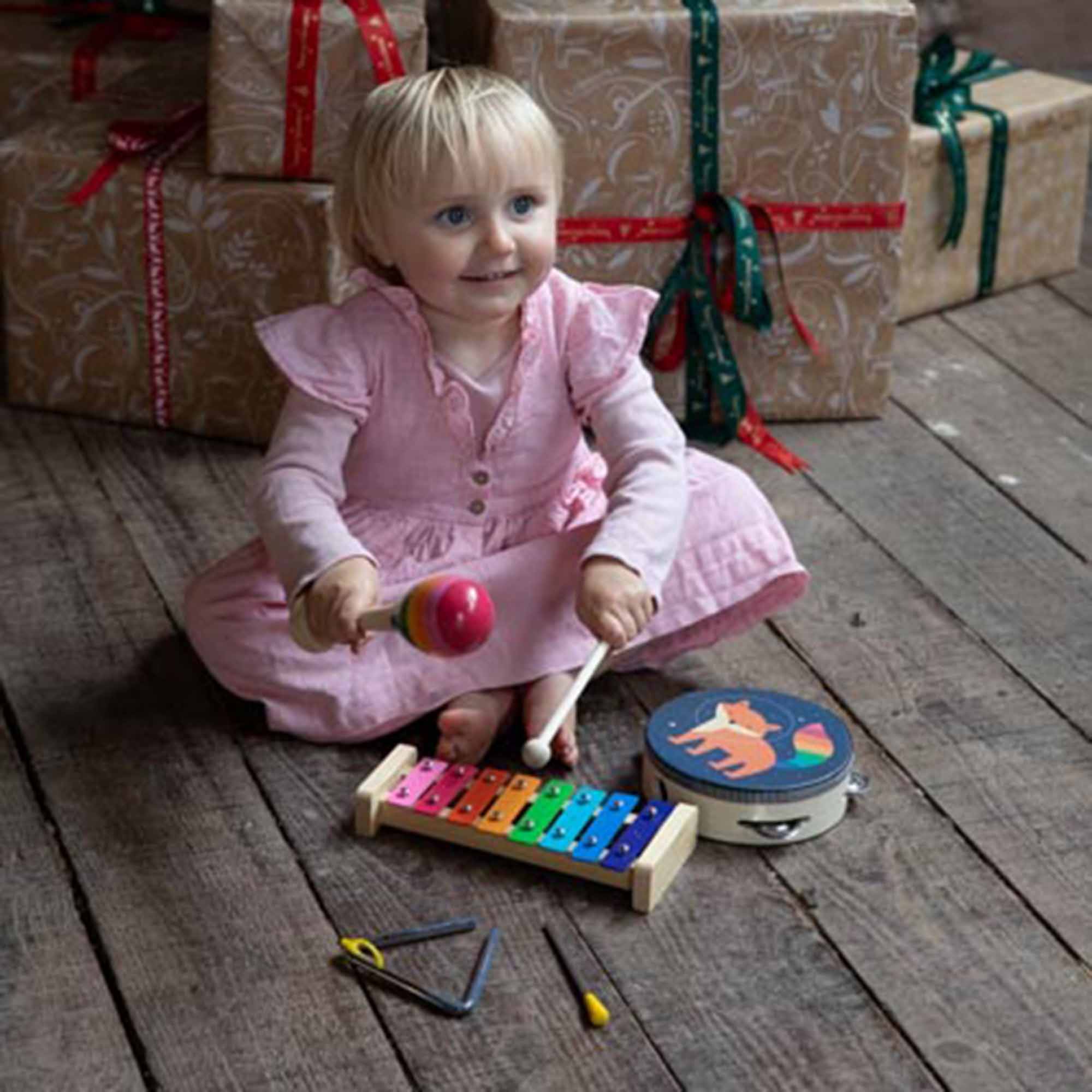 Little girl playing with the music set