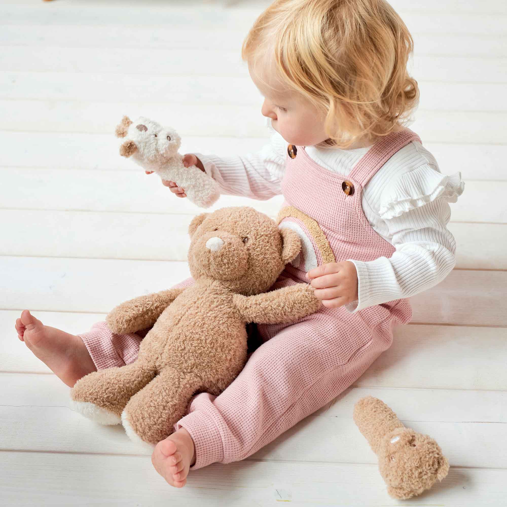 Child with Cuddly Bear and Rattles
