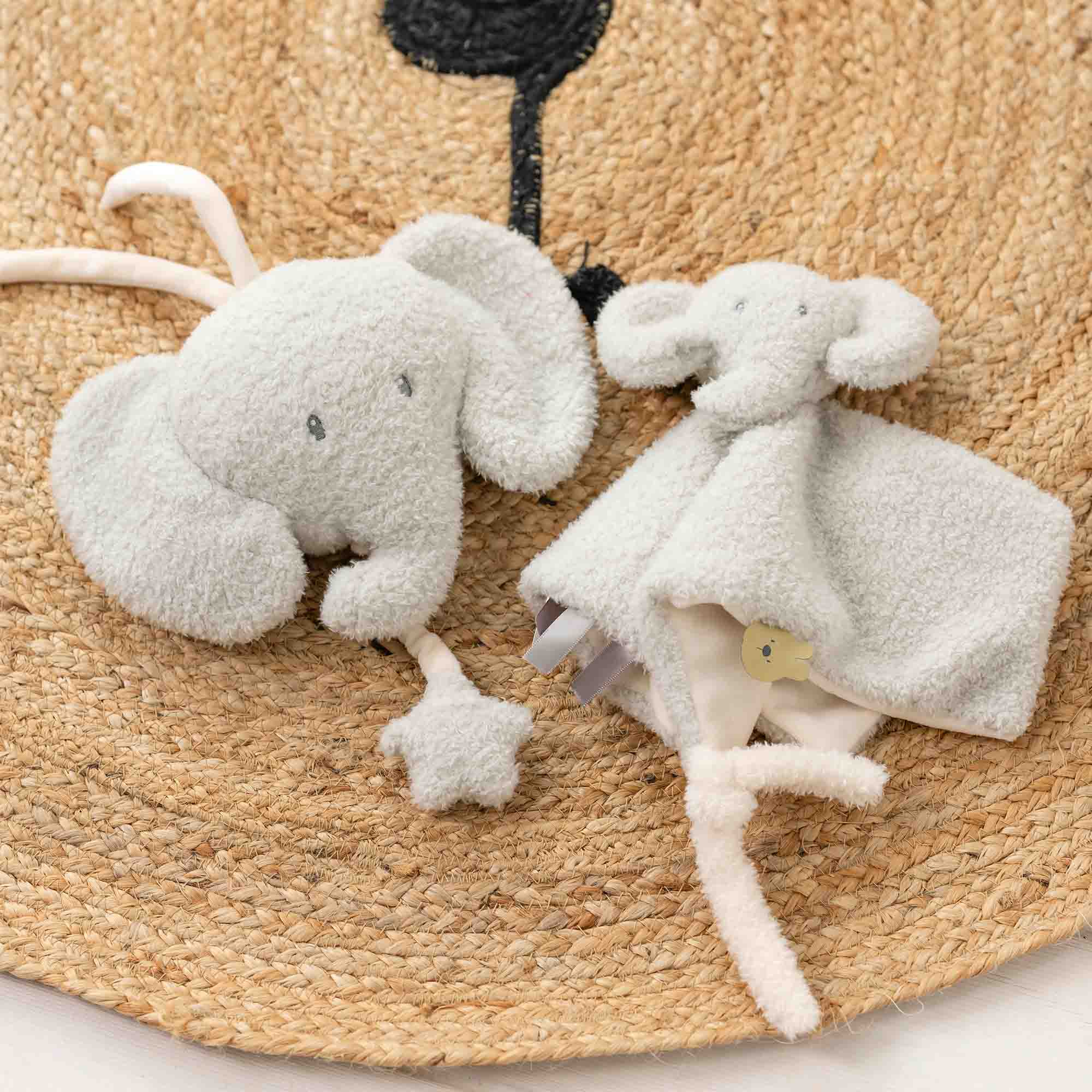 Musical toy elephant next to a elephant doudou