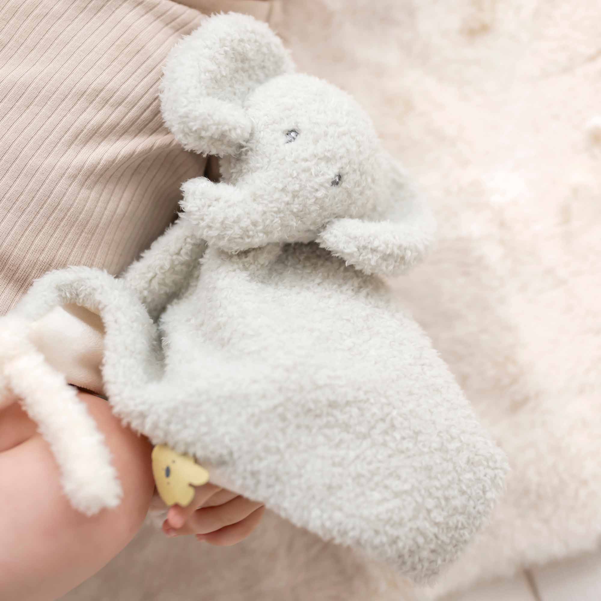 Baby holding Elephant Doudou