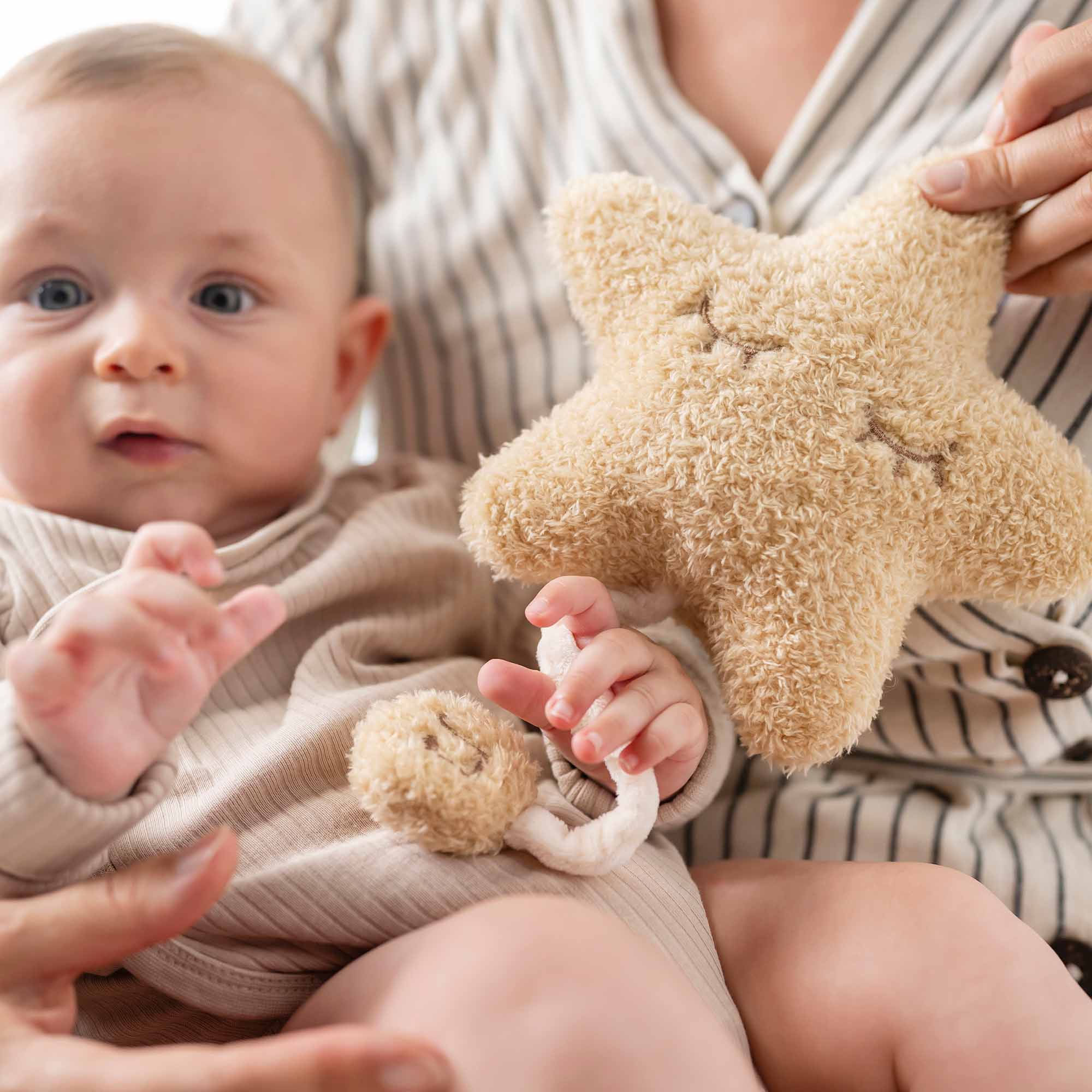 Baby holding Star Musical Toy