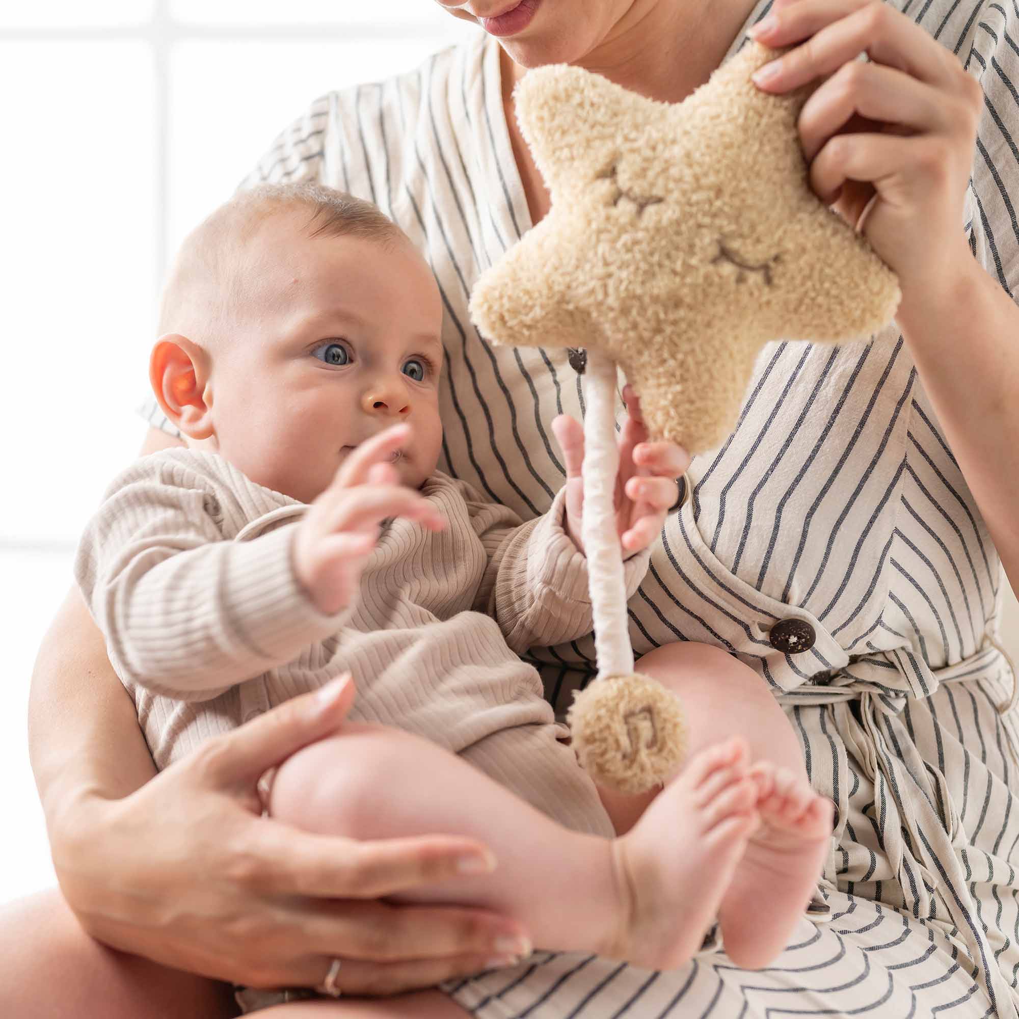 Baby holding Star Musical Toy