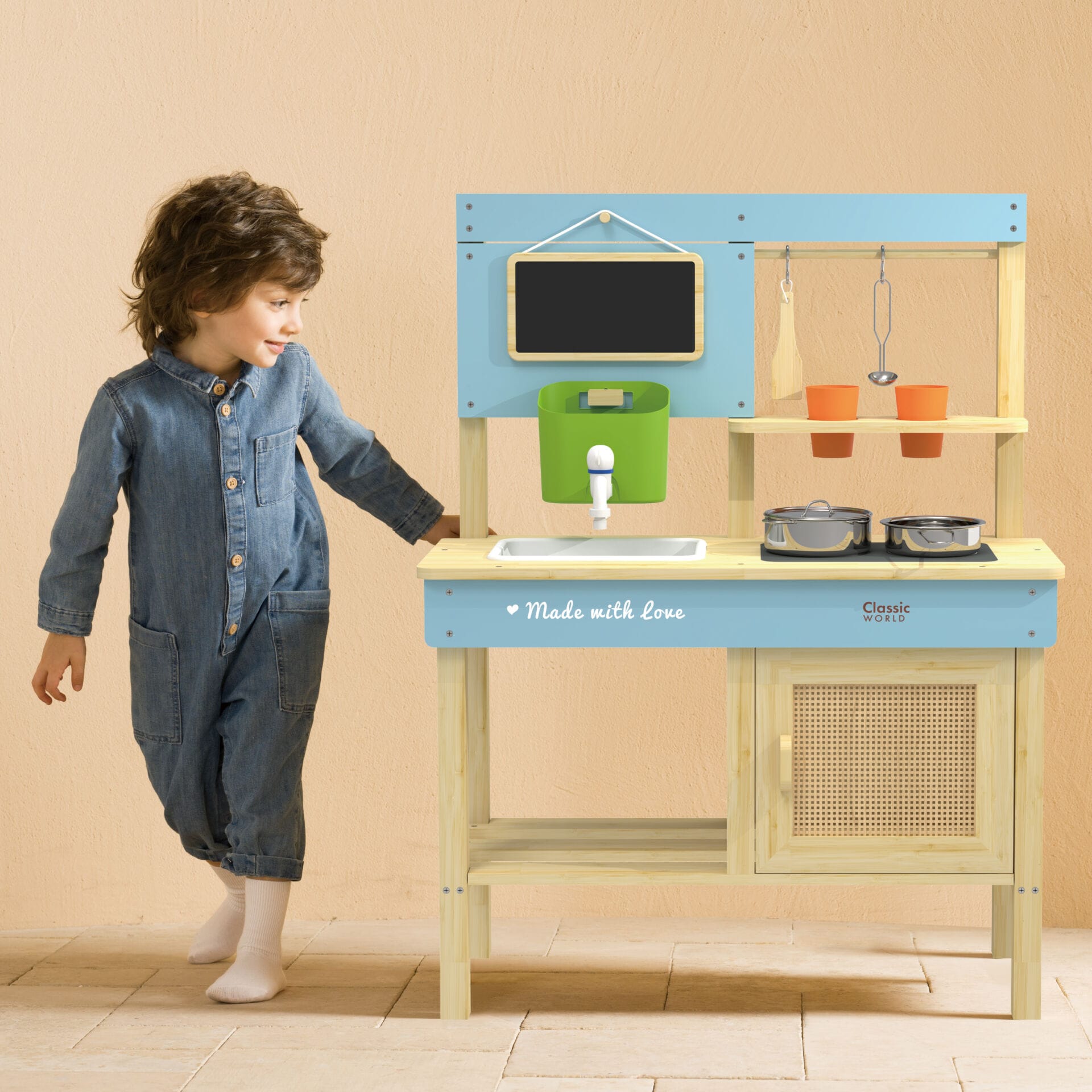 Child playing with the Classic World Outdoor Kitchen