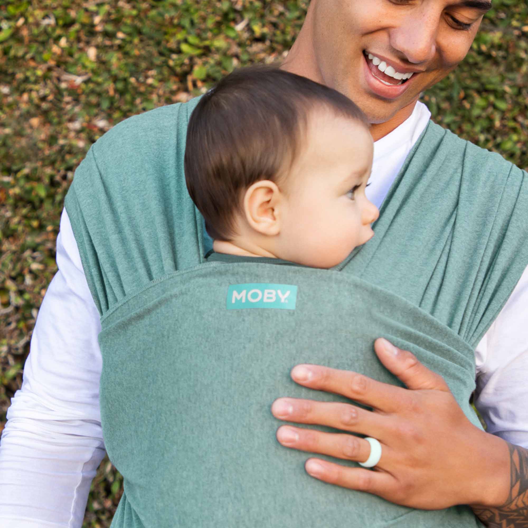 Father carrying baby in Moby Elements Hydro Wrap