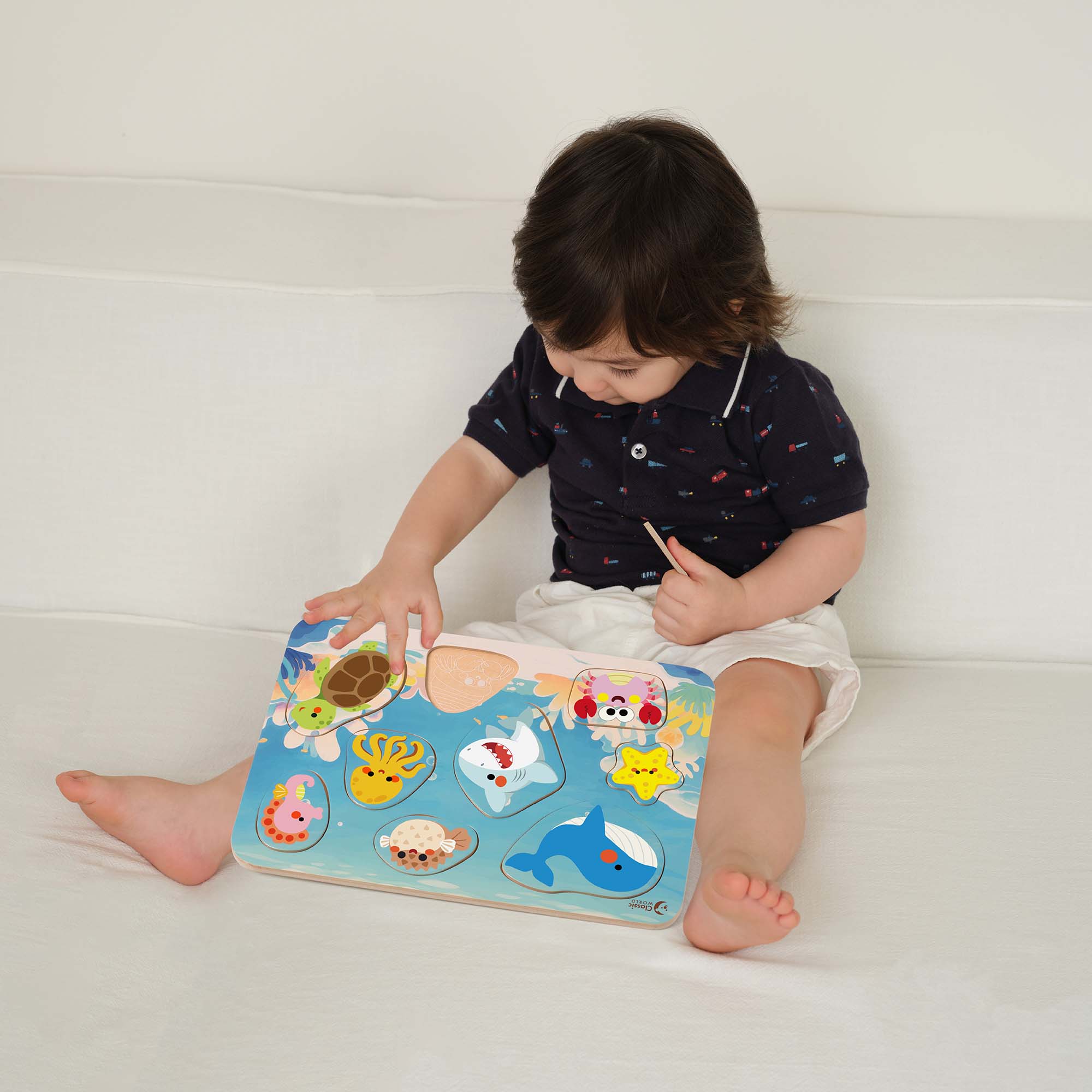 Boy playing with the Classic World Ocean Puzzle