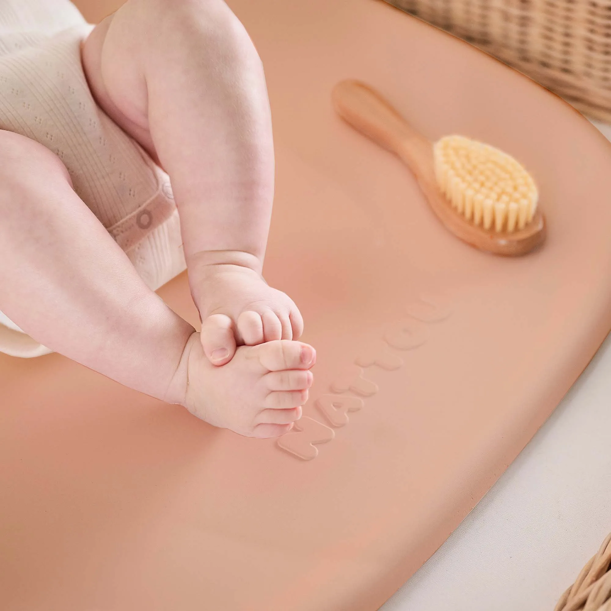 Close up of the baby's feet on the Nattou Softy Peach
