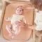 Baby lying on the Nattou Softy Peach
