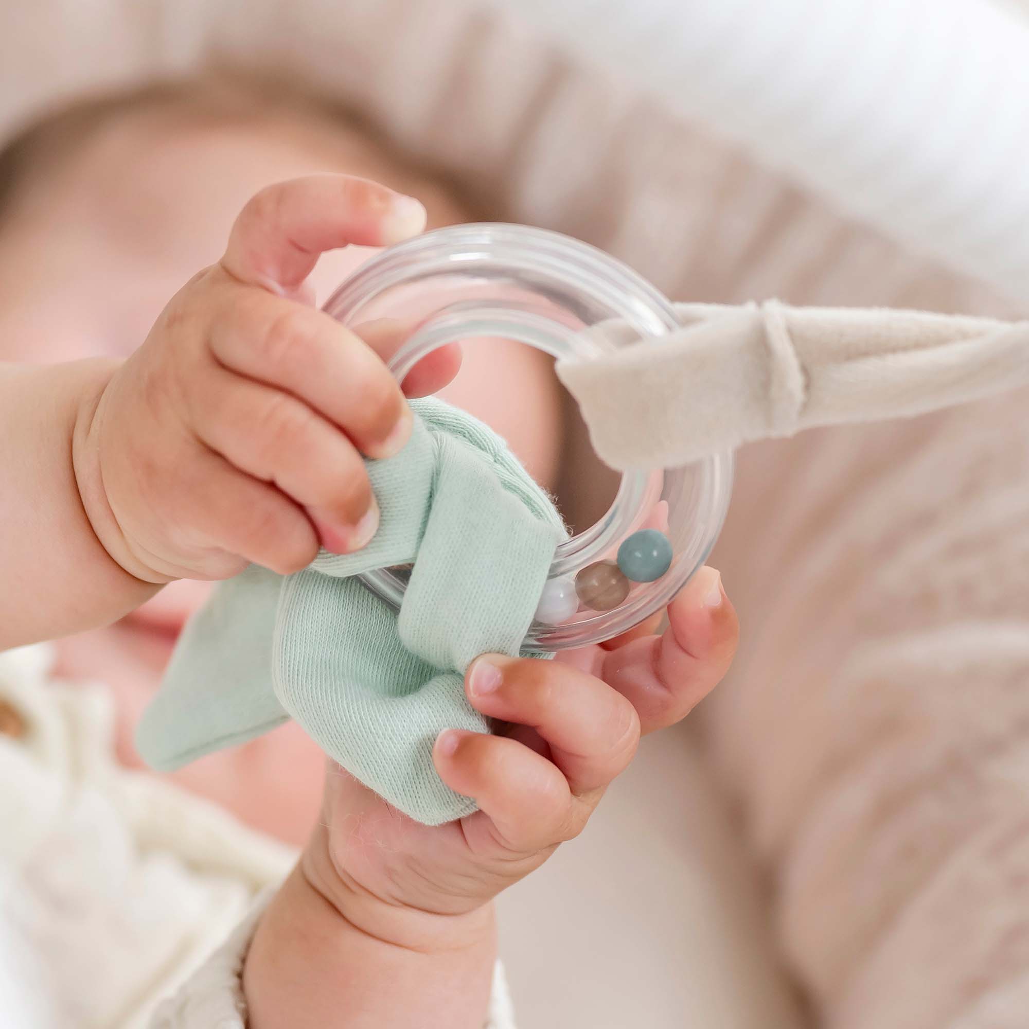 Baby playing with the Nattou Flo, Ernest and Oli - Stuffed Playmat With Arches