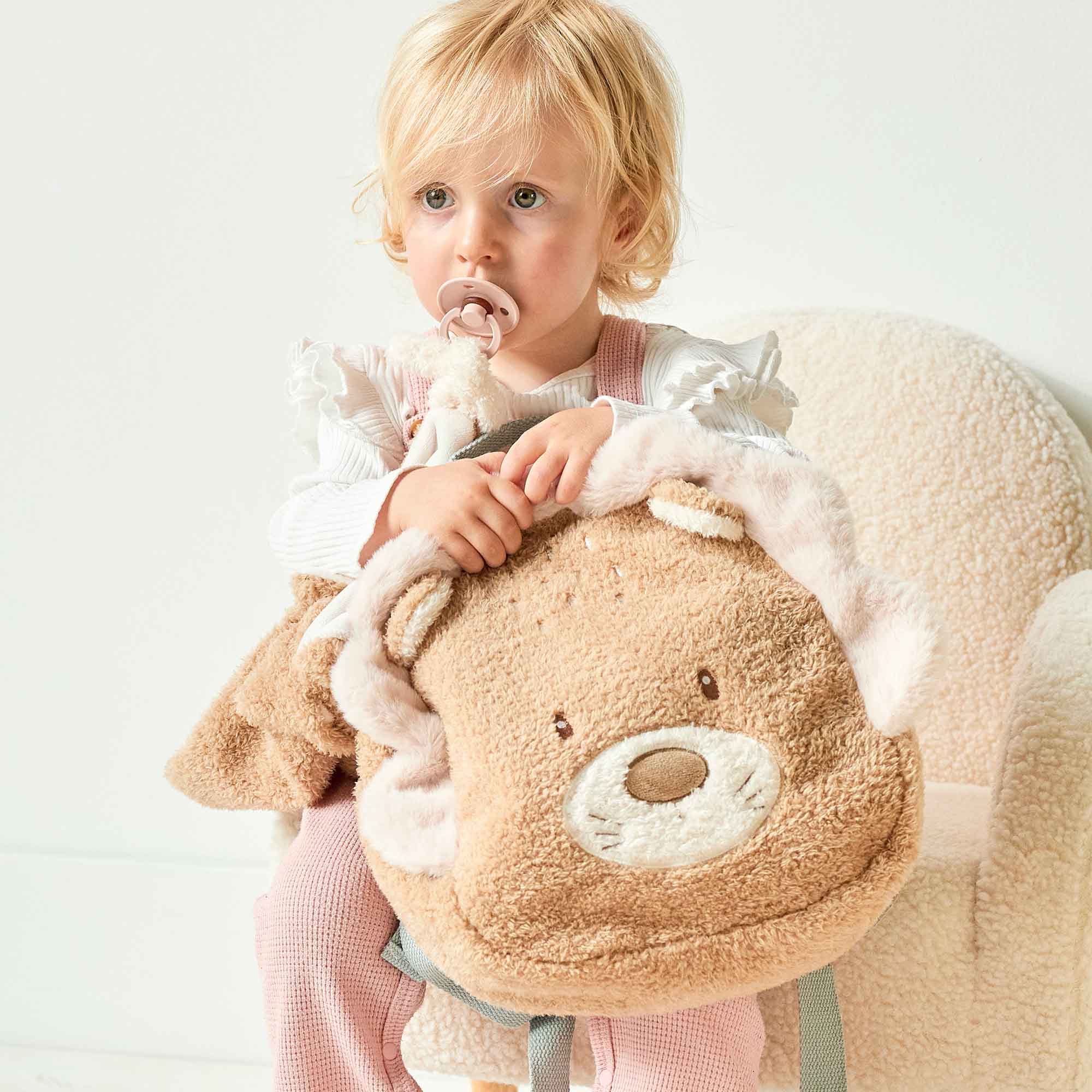 Girl holding the Lion Teddy Backpack
