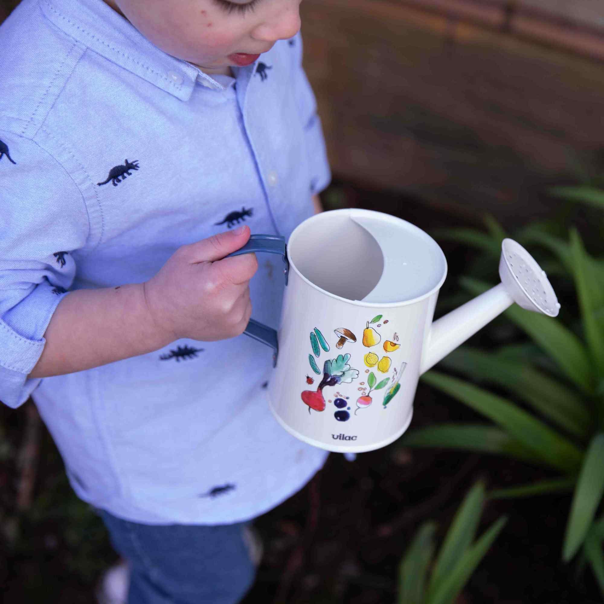 Boy holding the watering can
