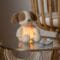 Dog Cuddly Nightlight on a table with the warm yellow light on