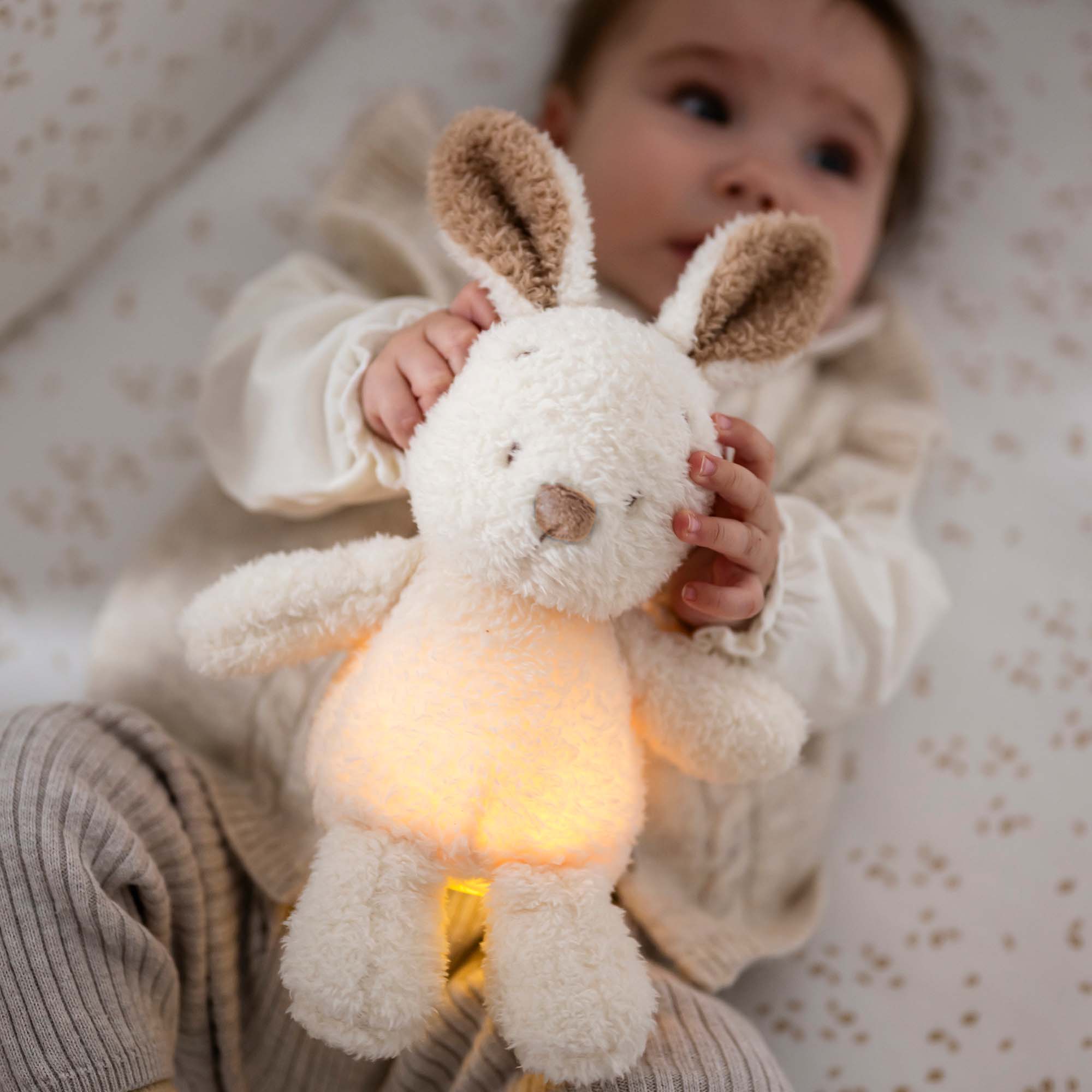 Baby holding the Bunny Cuddly Nightlight