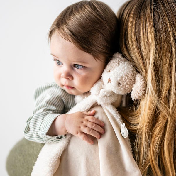 Girl cuddling Dog DouDou