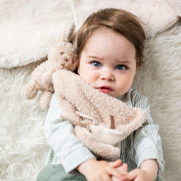 Child hugging the Bunny DouDou