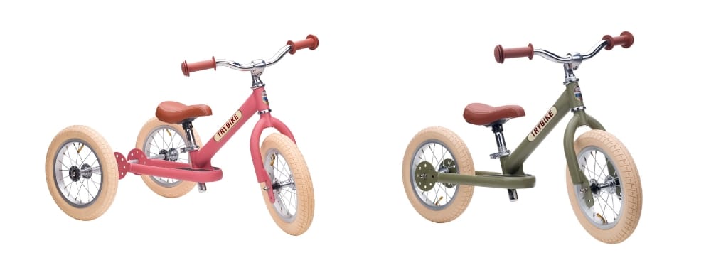 Pink 3-wheeled Trybike next to a green 2-wheeled Trybike