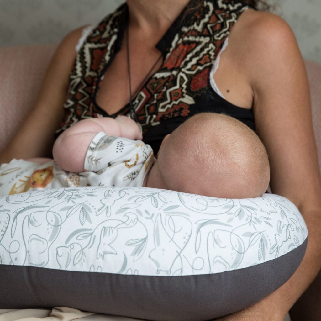 Mother feeding her baby on the Hippychick Animal Friends Feeding Pillow