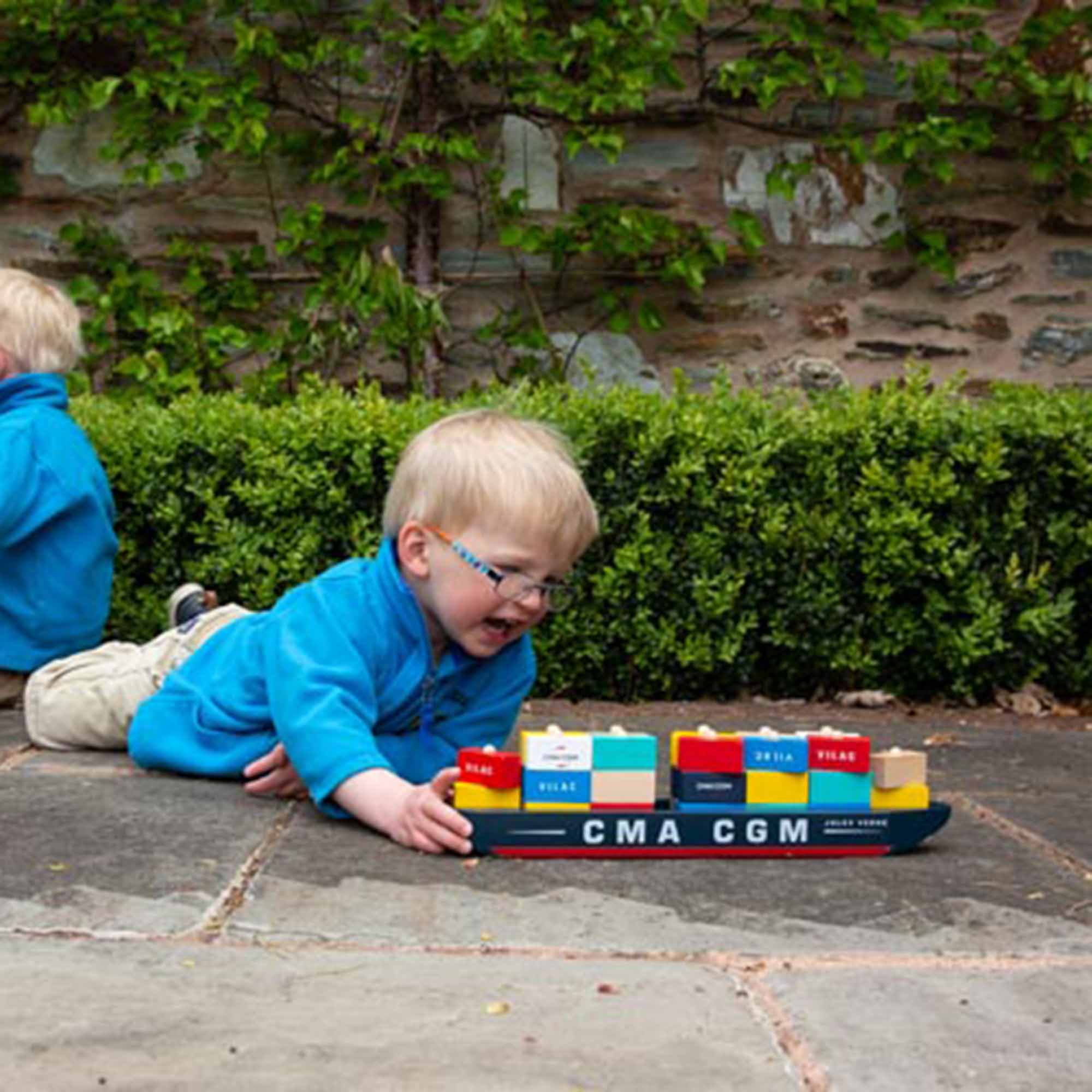 Boy playing with the Jacques Saade Container Ship